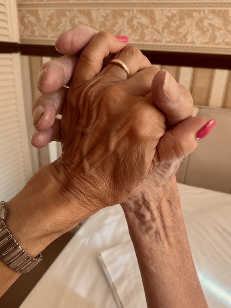 Gemma holding her mother's hands